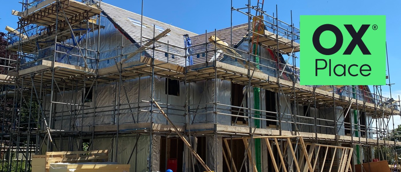 Homes under construction off Lanham Way, with OX Place logo