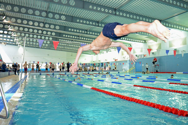 Person diving into swimming pool