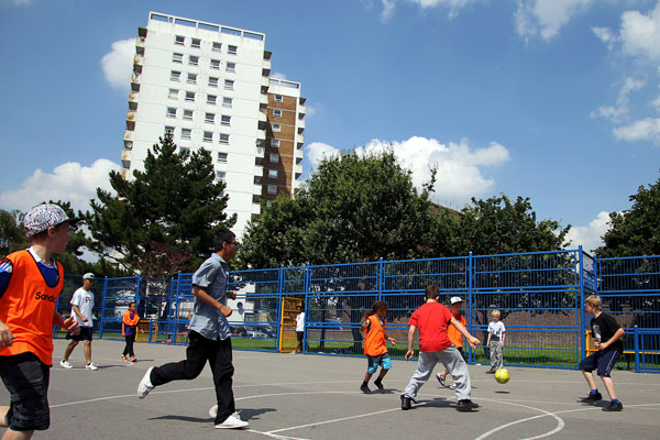 People playing football near tower block