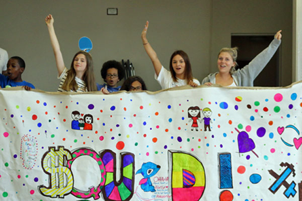 Group of young people holding a banner